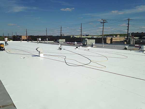 Single-ply TPO being installed by professionals